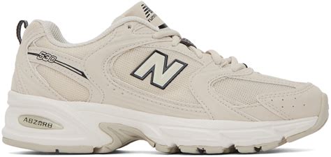 new balance 530 sneakers in white and beige